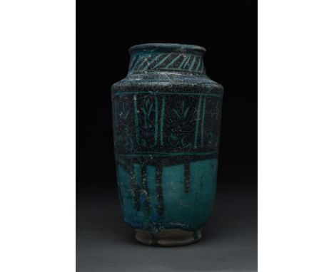 Kashan, Persia, ca. 1200-1300 AD. A pottery albarello jar, originating from the historic city of Kashan. The jar's striking a