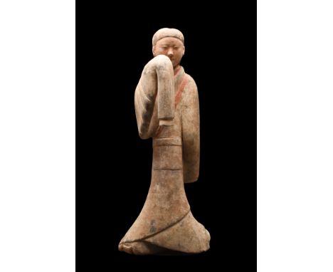 Ca. 202 BC-220 AD. A large grey earthenware figure of a female dancer wearing flowing, long-sleeved robe decorated with red i