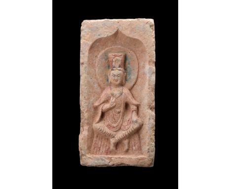 Ca. 386-534 AD. A grey pottery tile is rectangular in shape, with a recess on one face. It features a relief depiction of a s