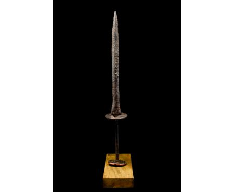 Ca. 14th-15th century AD. An iron dagger / stiletto with a slender blade tapering to a point, a round cross guard embellished