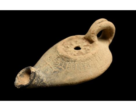 Judean, Late Roman / Early Byzantine, ca. 4th-5th century AD. A ceramic oil lamp of a teardrop-shaped body that features a re