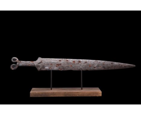 Ca. 600-400 BC. A finely decorated iron acinaces-type sword with a pointed, elongated triangular blade, B-shaped guard, recta