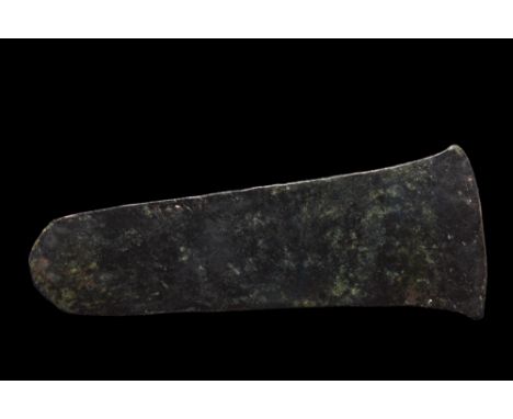 Ca. 1st millennium BC. A flat axe, with broad, curved cutting edge tapering gently to a rounded butt.Size: L:45mm / W:115mm ;