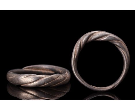 Ca. 900-1100 AD. A Viking silver ring featuring a twisted median section that symbolizes the interconnectedness of life and t