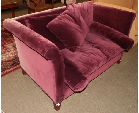 A two-seater sofa, modern, upholstered in purple plush velvet with assorted scatter cushions and squab cushion between rounde