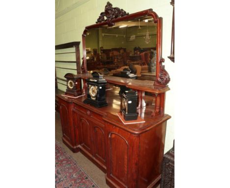 A Victorian mahogany inverted breakfront mirror-back sideboard, 3rd quarter 19th century, the carved pediment and mirror plat