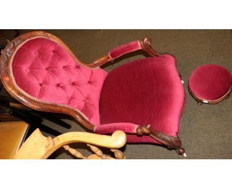 A Victorian carved mahogany framed button back open armchair and footstool upholstered in matching material 