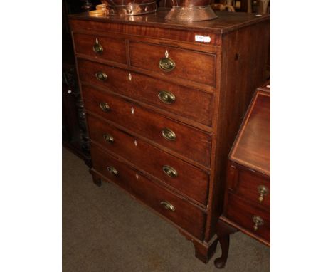 A George III oak six drawer straight fronted chest on bracket feet 