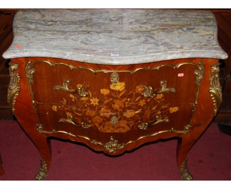 A Louis XV style walnut floral marquetry inlaid and further gilt metal mounted two drawer commode, of serpentine form, having