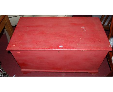 A 19th century and later red painted pine hinged top tool chest, of good size, having iron end carry handles, w.110cm