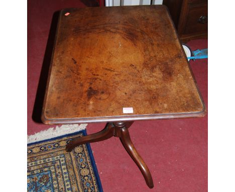 An early 19th century mahogany round cornered tilt-top pedestal tripod table