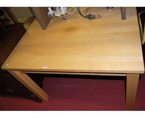 A contemporary light oak rectangular kitchen table, length 112cm