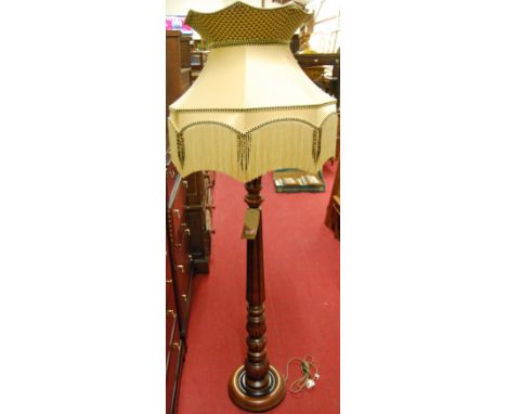 A contemporary turned cherrywood standard lamp, having a fluted column