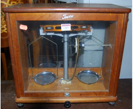 An early 20th century oak and glazed set of table-top weighing scales