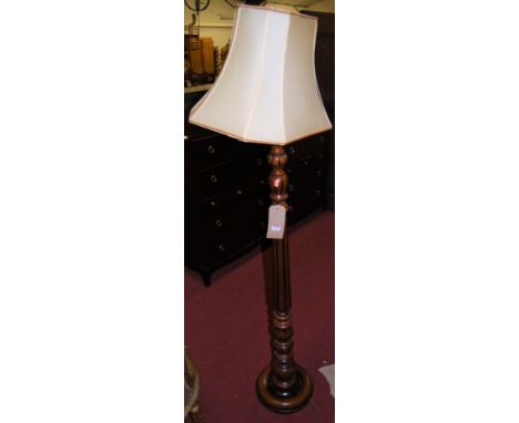 A contemporary turned cherrywood standard lamp, having a fluted column