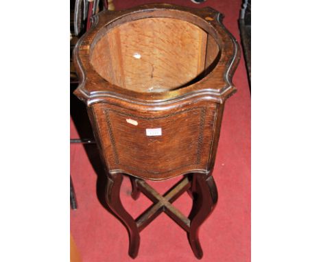 An early 20th century oak serptentine shaped planter