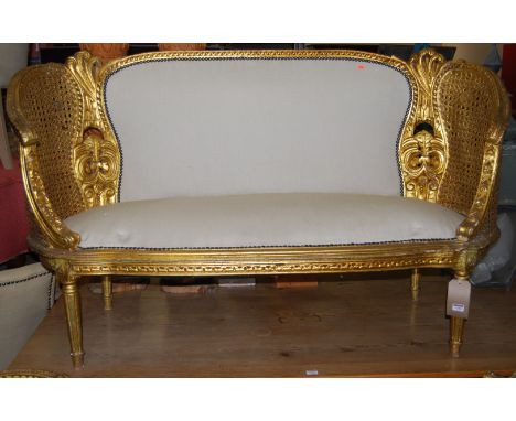 A contemporary giltwood, twin split cane inset and upholstered three-piece bergere suite, comprising two-seater sofa and pair