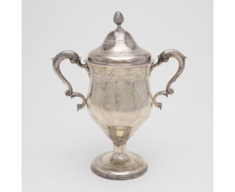 with twin leaf-capped scroll handles, a bright engraved frieze around the cover, rim &amp; around the foot and a fluted finia