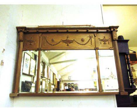 A 19th century overmantle mirror, the three rectangular mirrored plates within a giltwood surround decorated with classical u