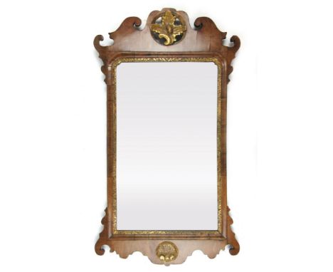 A George II and later wall mirror, the rectangular plate within a walnut and giltwood frame of typical form, 90 x 49 cm