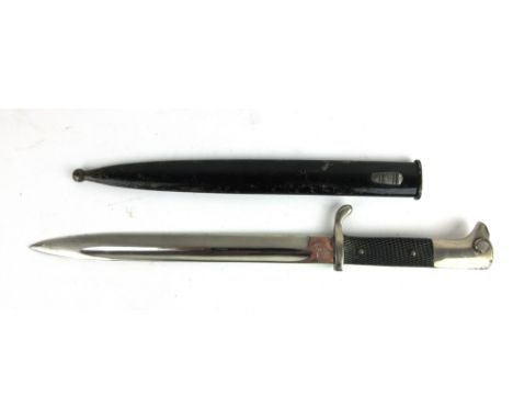 A WWII German bayonet, with black plastic grip and scabbard, chromed blade having helmet marks, and button lock, blade length