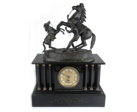 A Victorian mantle clock, the German movement striking on a bell, the enamelled and brass face with Arabic numerals within a 