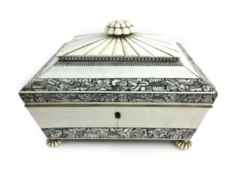 A 19th century Vizagapatam ivory sarcophagus shaped sewing box, with floral finial on gadrooned and florally engraved banded 