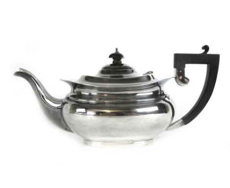 A squat silver teapot with an ebonised handle, Birmingham 1930, w. 746 grams, h. 16 cm