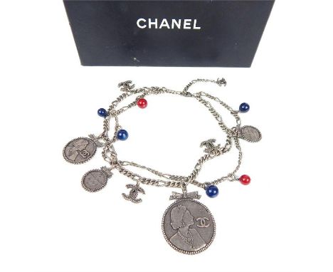 A vintage Chanel Ceinture silver belt / necklace, decorated with various medallions and blue and red glass beads complete wit