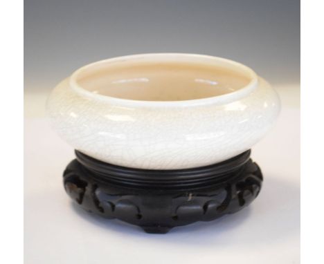 Porcelain censer with cream crackle glaze, probably Japanese, on hardwood stand, 15cm diameter Condition: Interior with stain