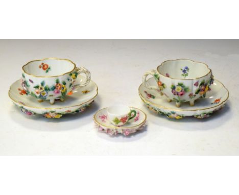 Pair of Meissen cups and saucers with encrusted and painted floral decoration, together with a Meissen pin dish, and a miniat