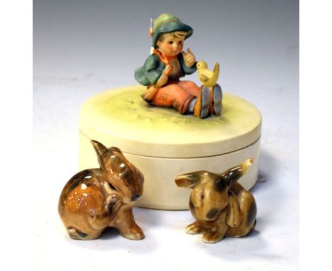 Hummel lidded box, and two Continental porcelain rabbits, 13cm high and smaller Condition: Hummel figure has losses to necker