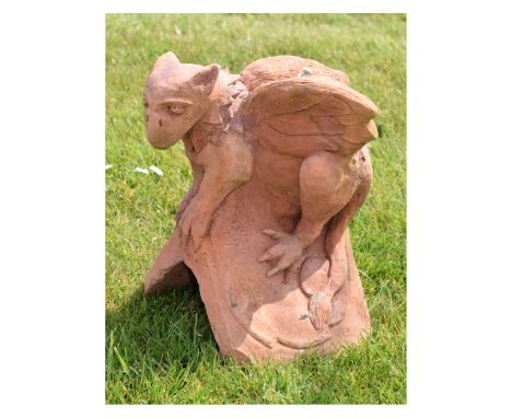 Terracotta capping stone/finial in the form of a seated dragon, 30cm high Condition: Some minor nibbles to the edges, please 