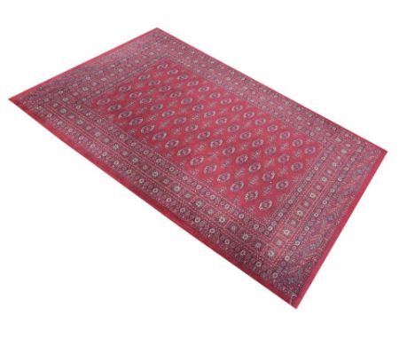 Modern machine made wool rug having central oval panel decoration on a red ground, 160cm x 230cm Condition: Would benefit fro