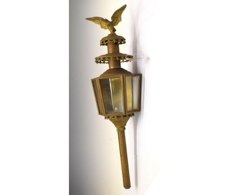 Single brass carriage lamp, having eagle finial to top, 74cm long Condition: Signs of oxidisation in places and damage to the