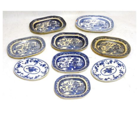 Nine Willow Pattern meat plates, etc, largest measuring 56cm wide approx Condition: Loss of decoration in places to all of th