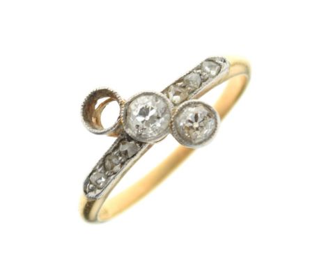 18ct gold, platinum and diamond dress ring, having two (of three) larger stones diagonally-set over six smaller, shank stampe