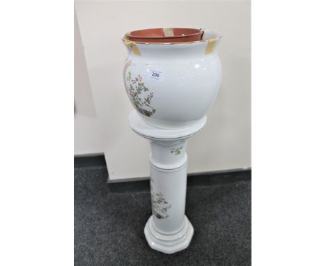 A decorative ceramic jardiniere on stand 