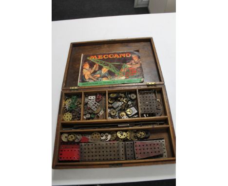 A vintage wooden box containing Meccano