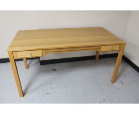 A light oak office desk together with office pedestal and swivel armchair , width 150 cm, 74 cm height and 75 cm depth.
