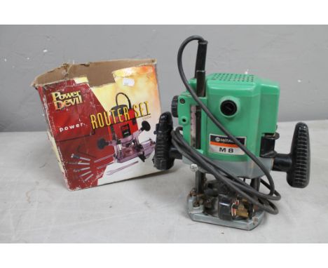 A quantity of tools to include electric router, router cutter, boxes of garnet paper, electric table saw