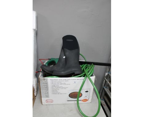 A box containing hose pipe, pair of boots, hedge trimmer