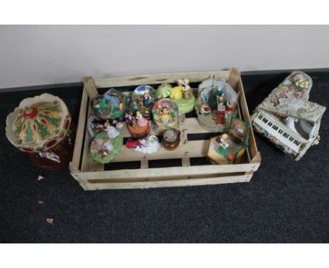 A crate of decorative globes, ornamental ceramic piano, musical figures etc 
