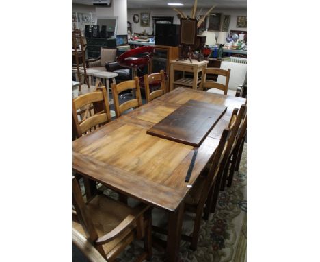 A good quality reproduction farmhouse extending dining room table together with a set of eight ladder back chairs 