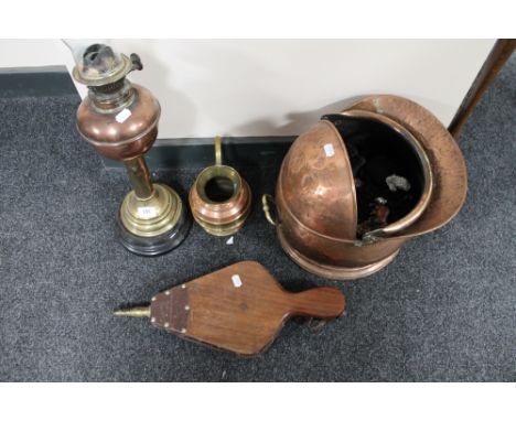 An antique brass and copper oil lamp together with copper coal helmet, pair of bellows etc