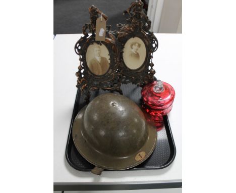 A pair of Art Nouveau style picture frames, warden helmet and cranberry glass dish