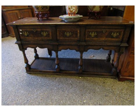 OAK FRAMED AND BURR OAK BANDED DRESSER BASE WITH THREE DRAWERS WITH TURNED SUPPORTS AND OPEN SHELF   