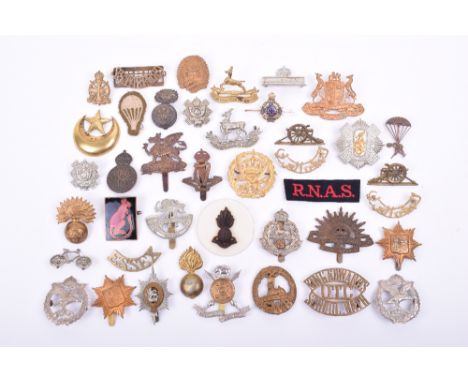 Grouping of Various Cap Badges, Collar Badges & Shoulder Titles, including brass Grenadier Guards NCO’s cap badge, white meta