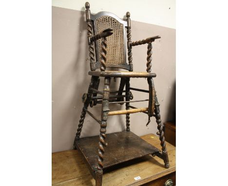 A VINTAGE "MILLSON'S" OAK BARLEY TWIST CHILD'S HIGH CHAIR WITH CANE WORK SEATS