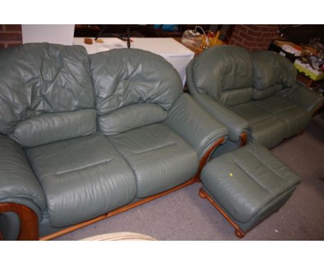 A PAIR OF GREEN LEATHER TWO SEATED SOFA TOGETHER WITH MATCHING FOOTSTOOL